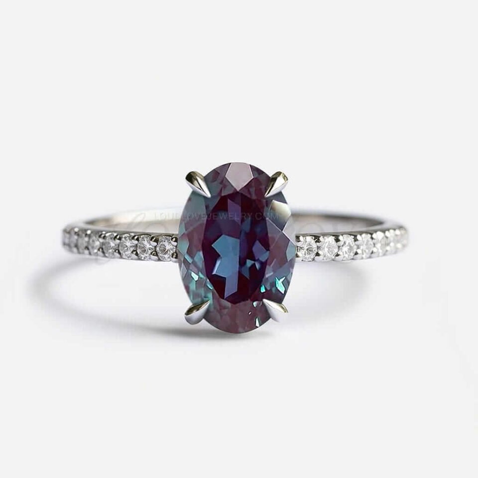 Oval lab alexandrite in 4-prong setting with white gold half eternity band.