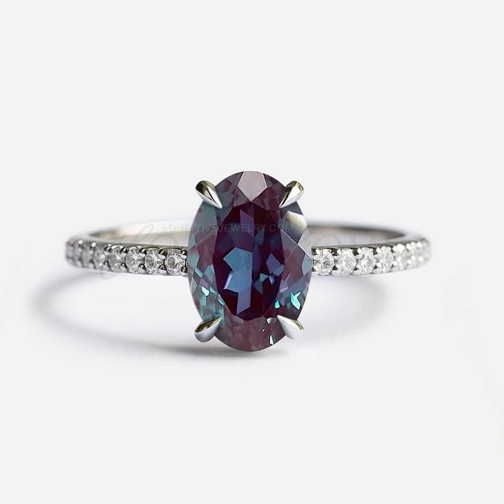 Oval lab alexandrite in 4-prong setting with white gold half eternity band.