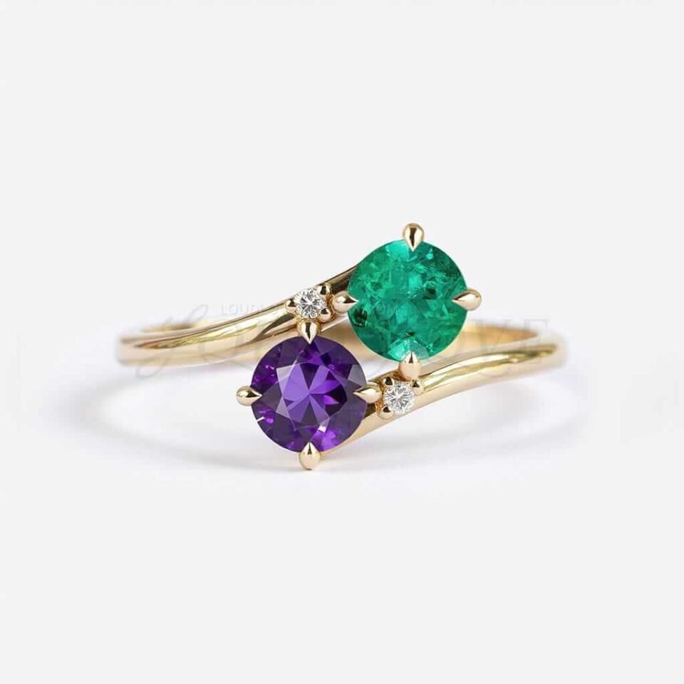 Round amethyst and lab emerald in a bypass setting with two white accent stones.