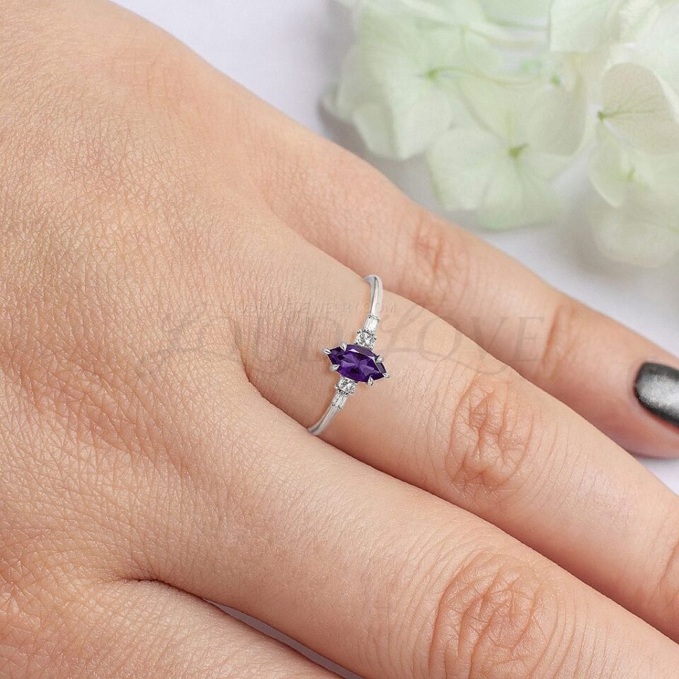 Elegant five-stone white gold ring with marquise amethyst and mixed cut side stones.