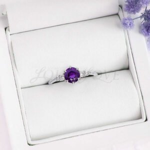 Silver five-stone design with vibrant round amethyst and moissanites, displayed in a ring box.