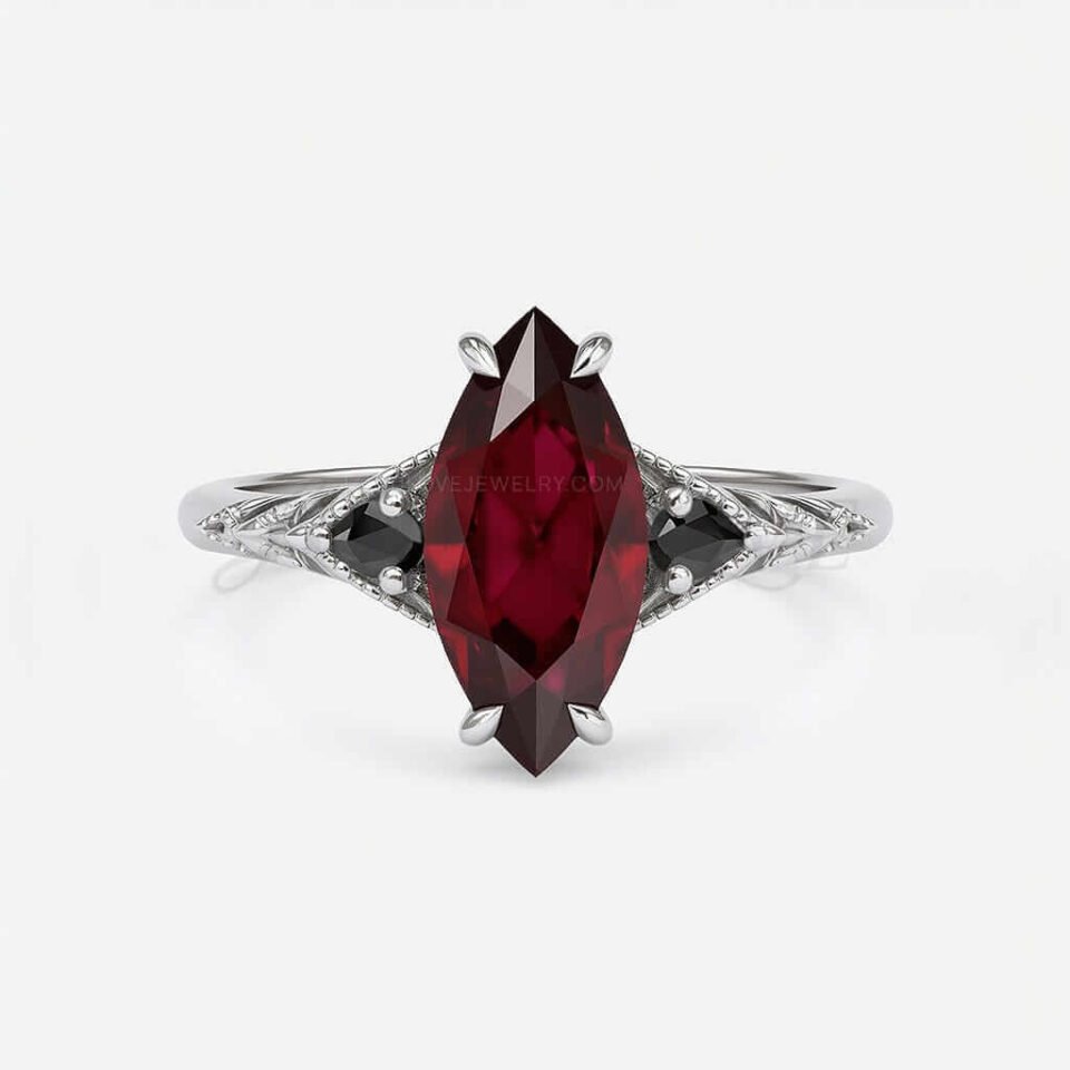 Antique-style ring with marquise garnet and pear-shaped black moissanites in textured milgrain band.