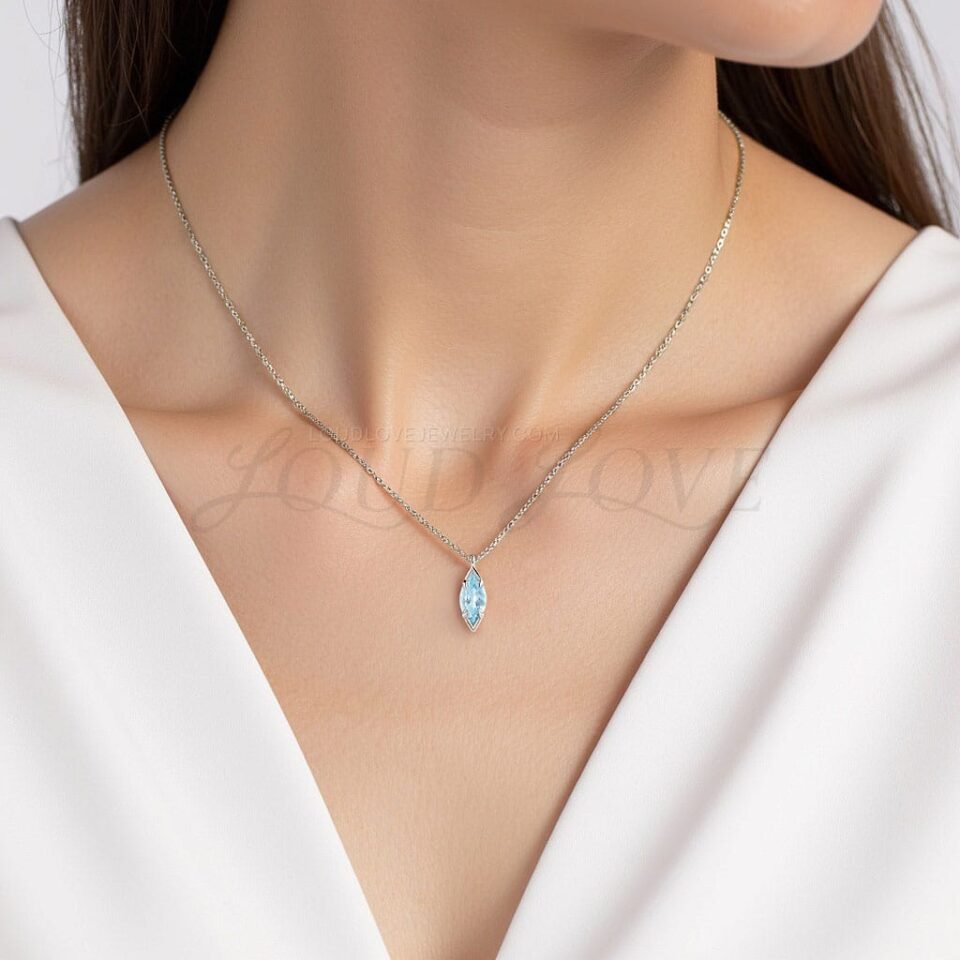 Sleek marquise aquamarine set in prongs, styled for a graceful March birthstone look.