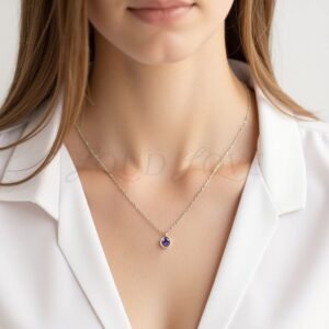 Bezel-set round amethyst necklace worn to mark February birthdays with elegant simplicity.