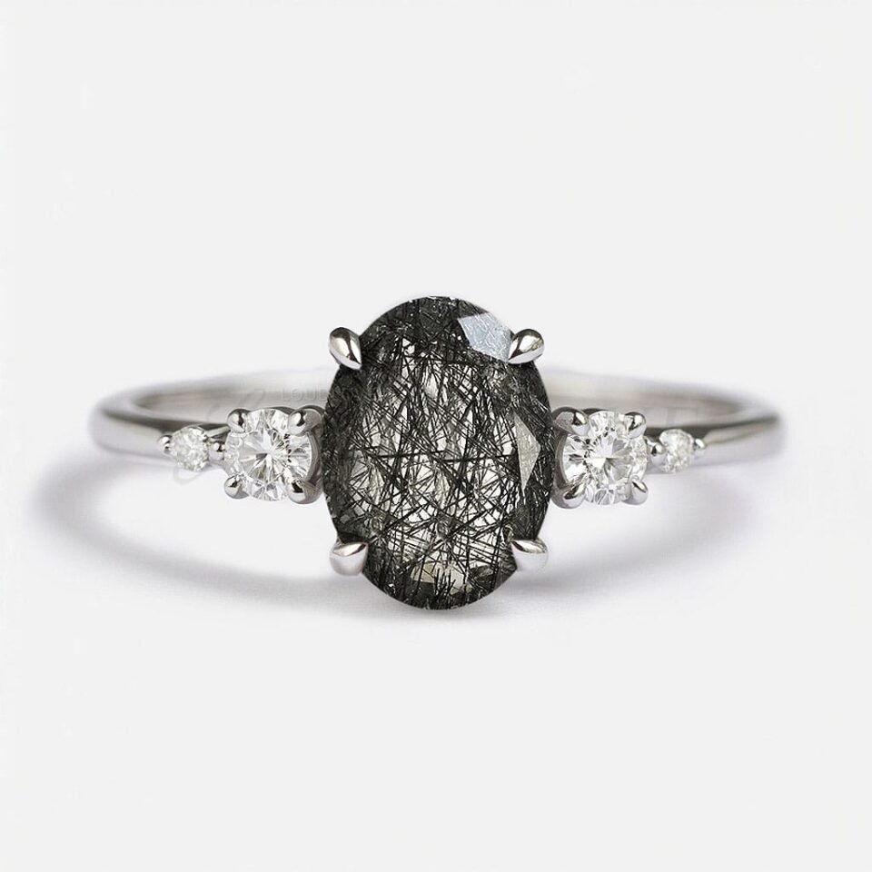 Oval black rutilated quartz ring with four round side stones, front view.