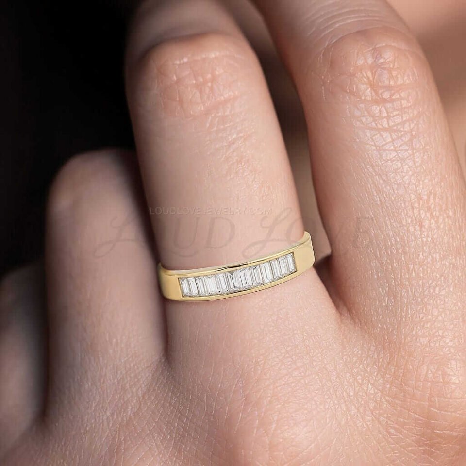 Men's ring in yellow gold with channel-set baguette diamonds across a broad band.