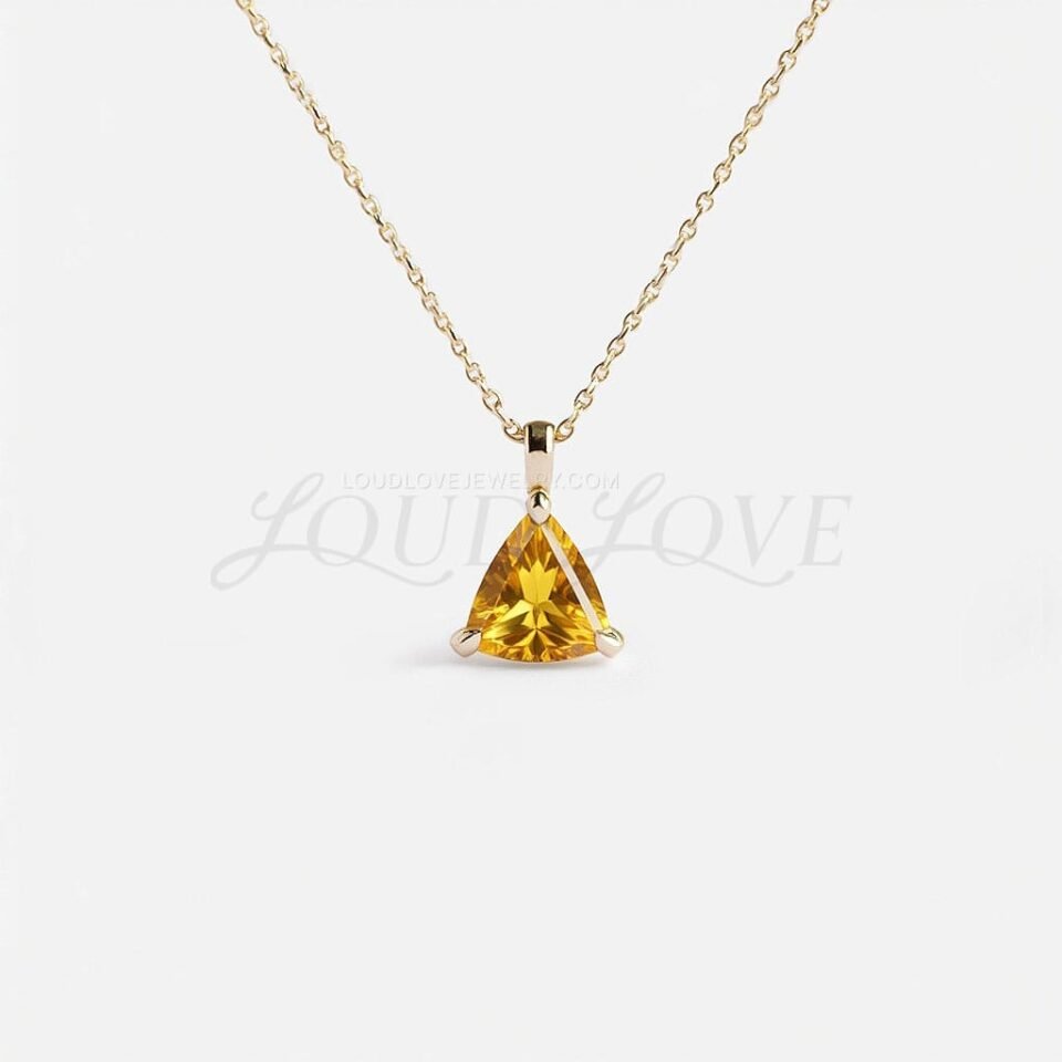 Trillion-cut citrine pendant in matching yellow gold, crafted as a chic and vibrant fashion piece.