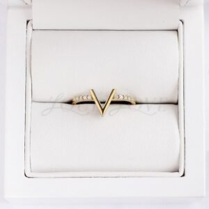 Pavé diamond V ring in gold displayed in a soft-lined case.