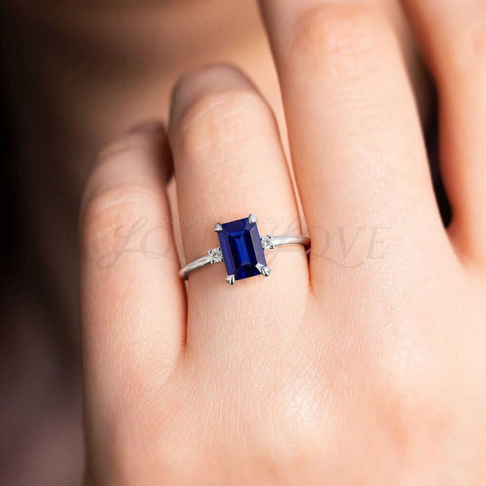Modern engagement ring with lab-grown sapphire and side stones styled in platinum.