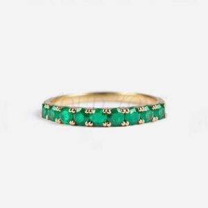 Half eternity ring with 9 round lab-grown emeralds on a 2.5mm wide band.