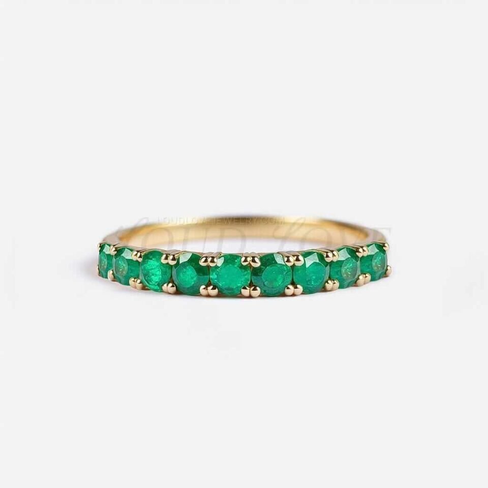 Half eternity ring with 9 round lab-grown emeralds on a 2.5mm wide band.
