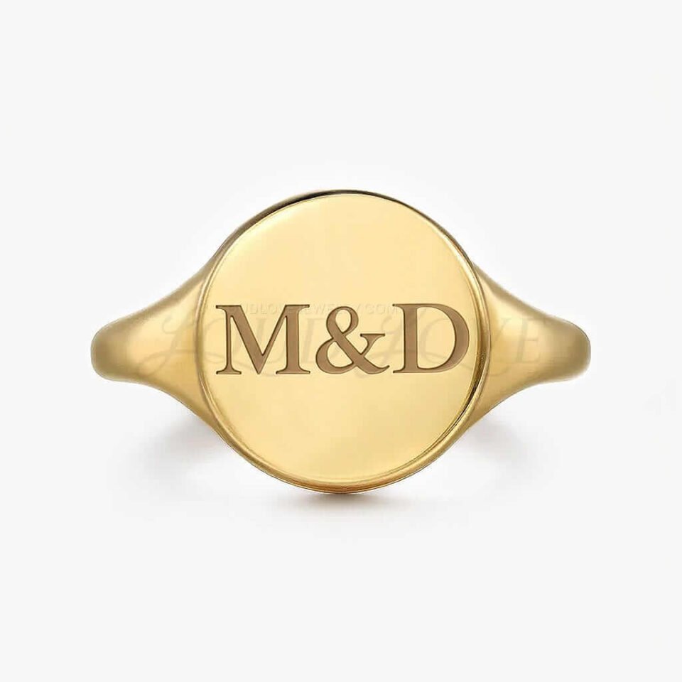 Gold ring with M&D engraving on a white background.