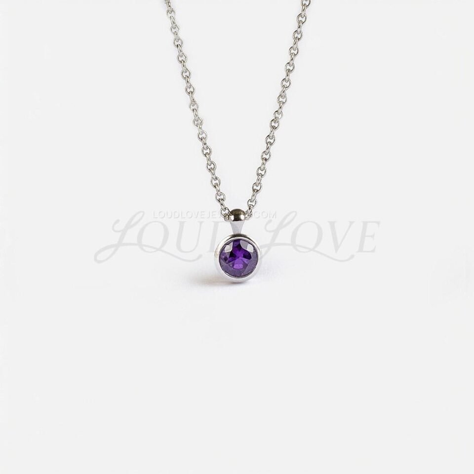 Round amethyst birthstone pendant in a smooth silver bezel, honoring February with rich purple tones.
