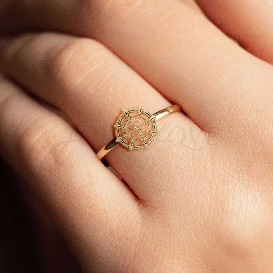 Girl with a ship wheel styled ring featuring a detailed steering wheel pattern.