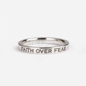 Silver ring engraved with 'Faith Over Fear' message.