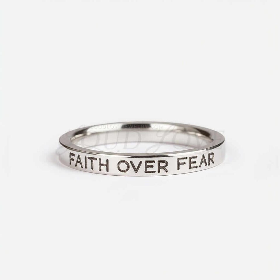 Silver ring engraved with 'Faith Over Fear' message.