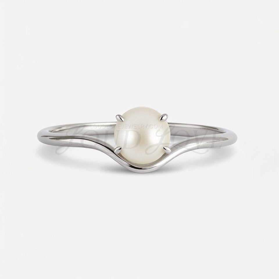 White gold ring with single pearl and curved marine-style design.