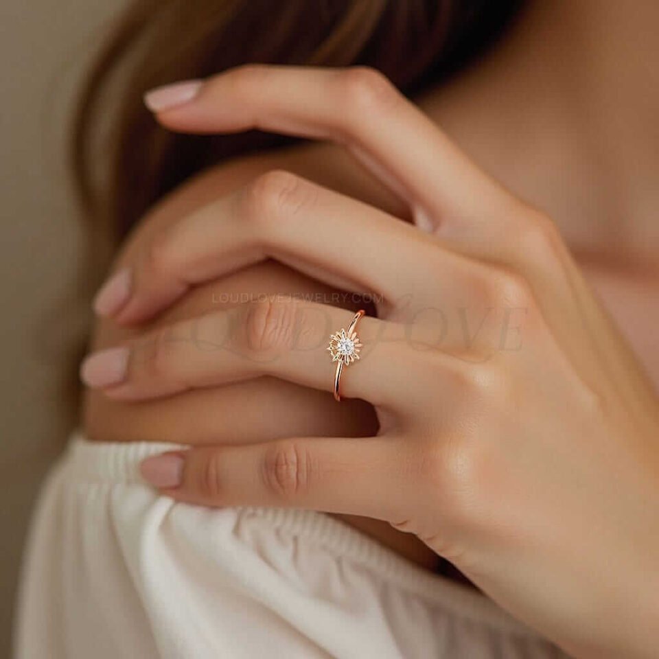 Lab diamond ring with gold starburst halo displayed on a woman's hand.