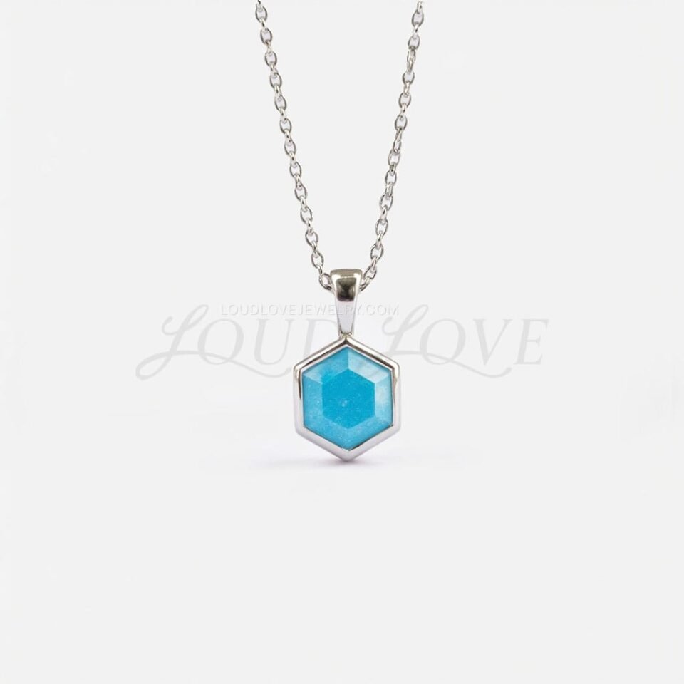 Hexagon turquoise pendant in white gold bezel frame, combining cool tones of metal and stone.