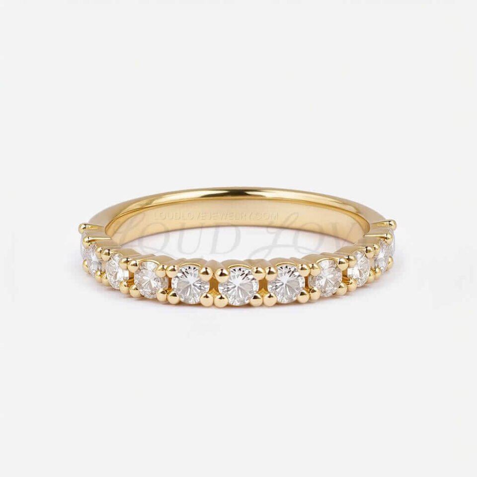 Classic half eternity ring with prong-set diamonds in a front-facing product view.