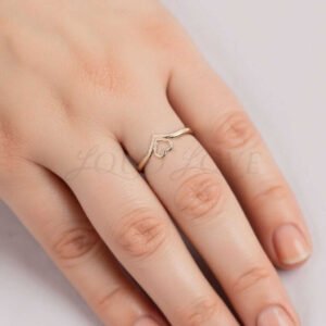 Female hands showcasing ring with a delicate and clean heart shape design.