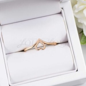 Minimalistic rose gold heart ring placed in a display case.