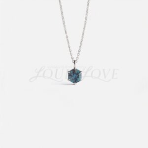 Hexagon-cut lab alexandrite in a white gold prong setting, displaying elegant color-shifting hues.