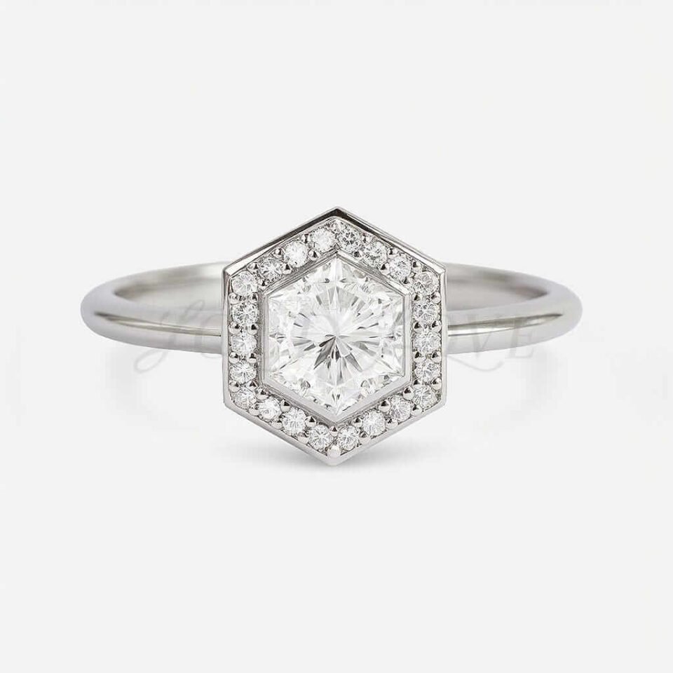 White gold engagement ring with bezel-set hexagon moissanite and channel halo.