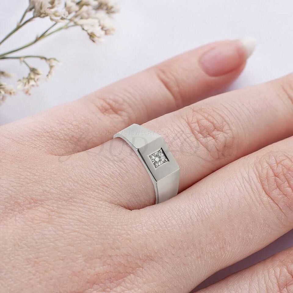 Masculine signet ring with round lab-grown diamond worn as a bold engagement or statement piece.