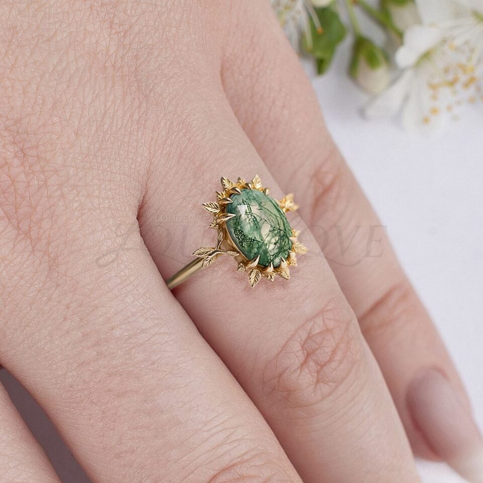 Leafy halo moss agate ring worn as a bold cocktail or artistic fashion ring.
