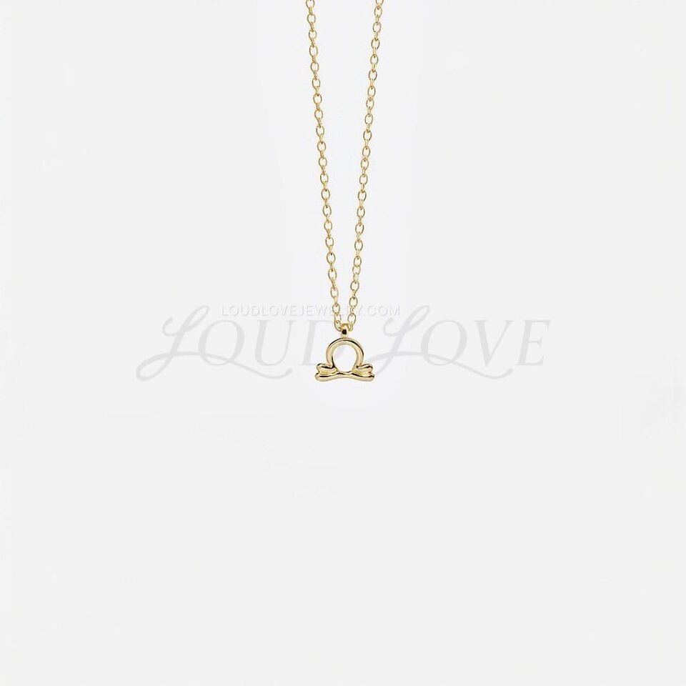 Libra necklace with balanced scales symbol crafted in gold, sleek and harmonious.