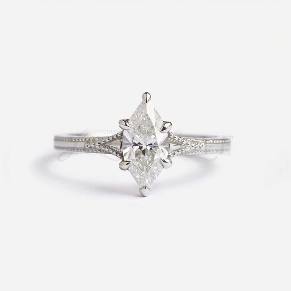 Moissanite marquise ring with milgrain detailing and wide white gold band, vintage design.