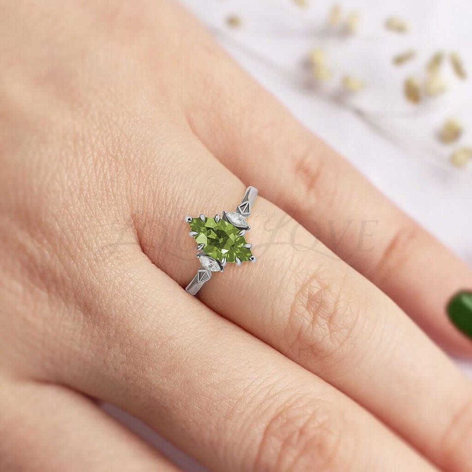 Marquise peridot flanked by white stones, detailed with bold geometric band.