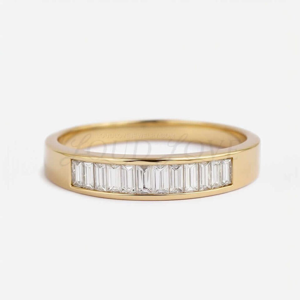 Yellow gold men's band featuring baguette diamonds.