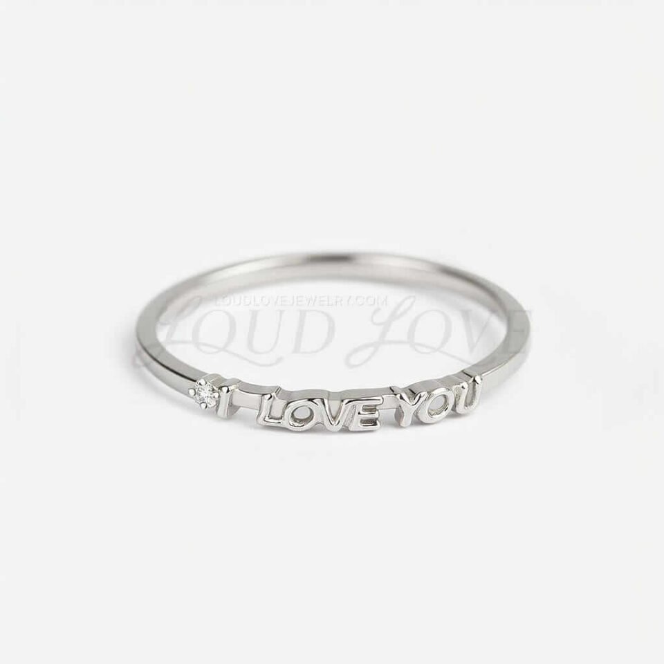 Front facing silver ring with the I love you text and a small moissanite or diamond.
