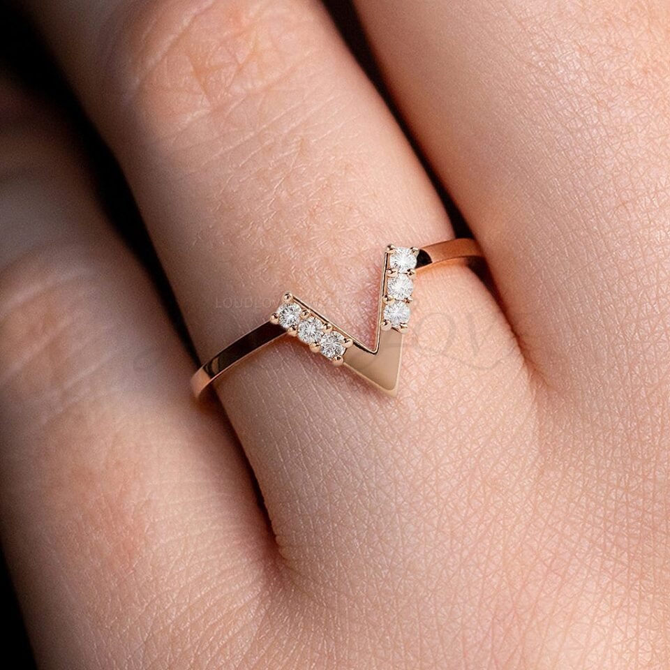V ring with round moissanites worn as a stackable wedding band.