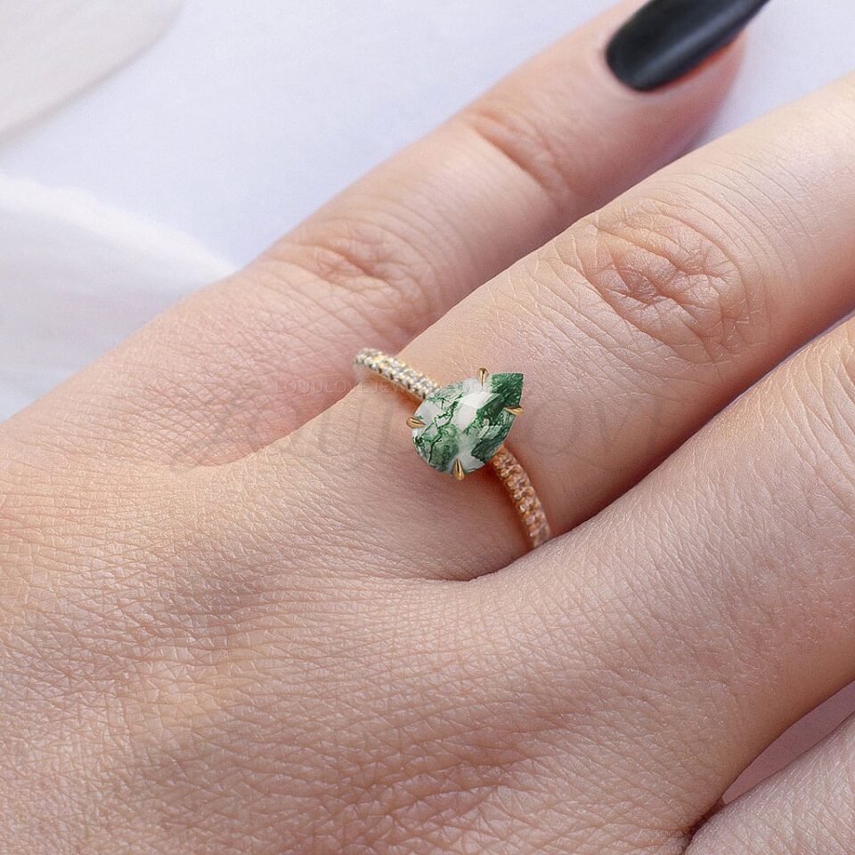 Pear moss agate ring with sparkling moissanite band worn as a bold statement piece.