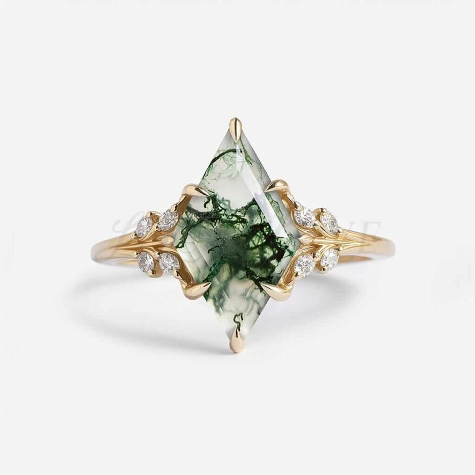 Lozenge moss agate engagement ring with 8-claw prongs and side stones.