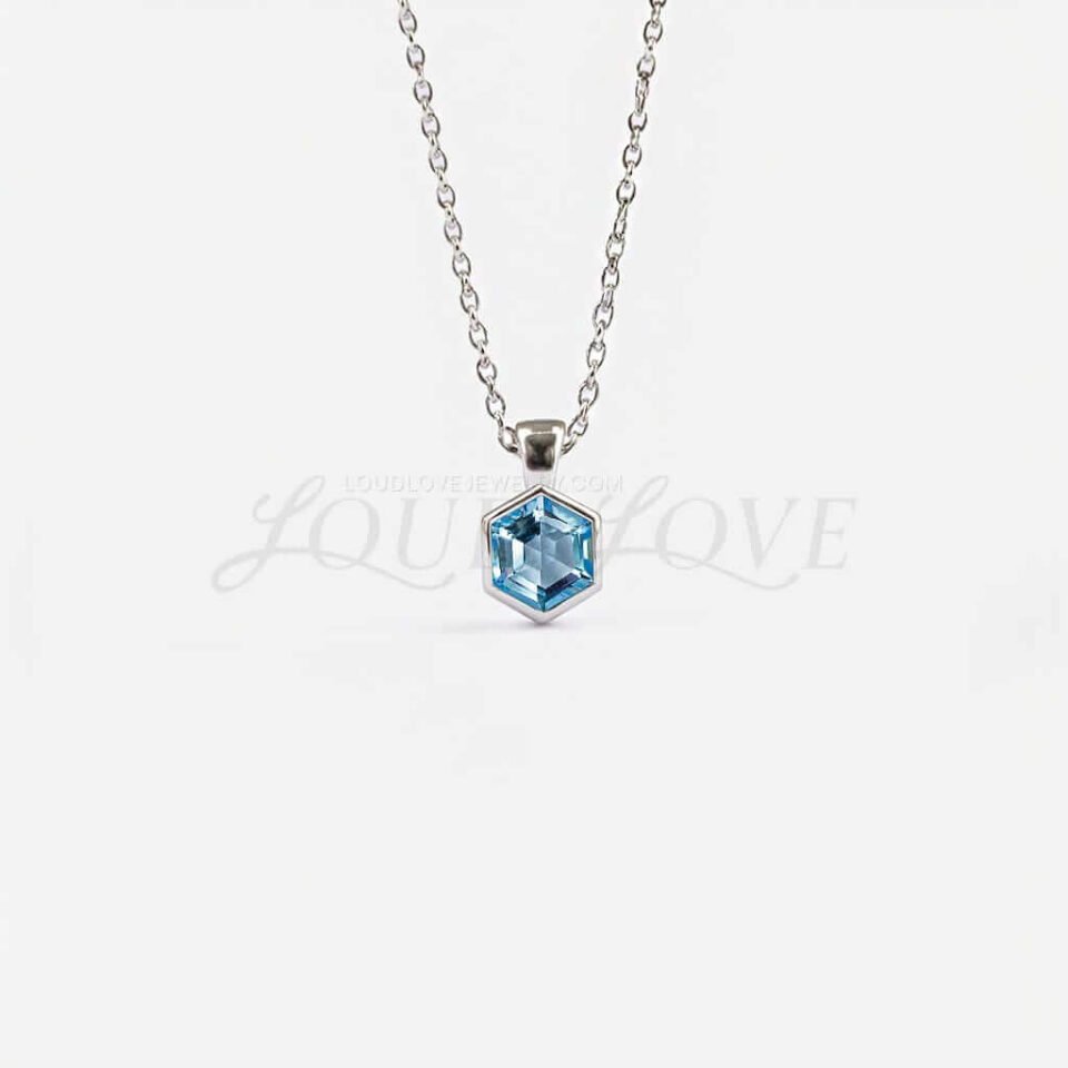 Hexagon-cut topaz set in a sleek bezel, celebrating November’s birthstone.