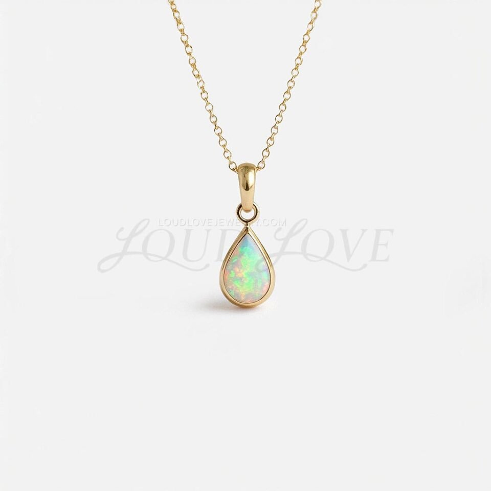 Pear-cut opal pendant in a bezel setting, glowing with October's signature iridescence.