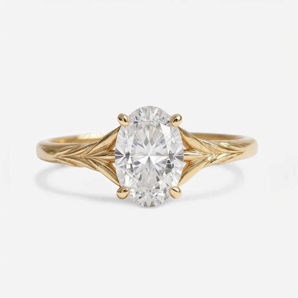 Oval cut moissanite in 4-prong setting with a textured tapered yellow gold band.