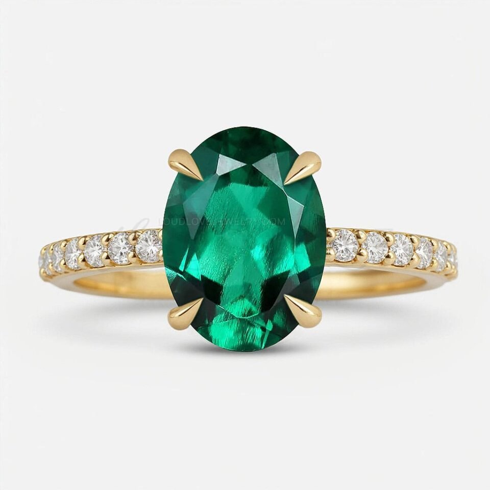 Lab-grown oval emerald in 4-prong setting with moissanite half eternity gold band.