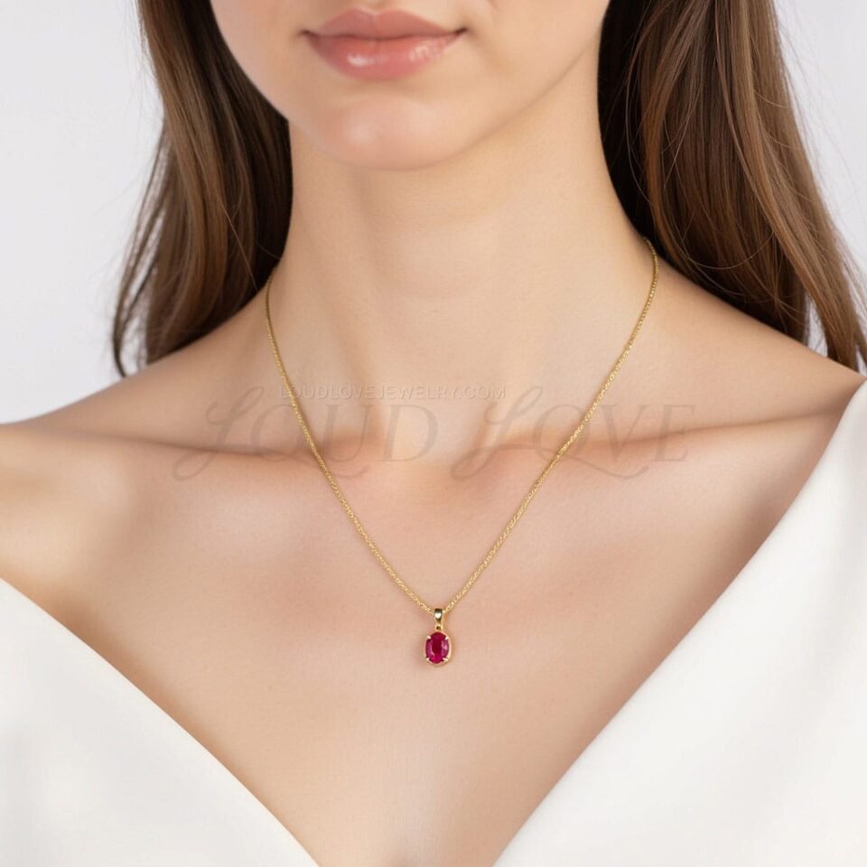 Yellow gold necklace with a vivid lab ruby, styled to represent July's gemstone.
