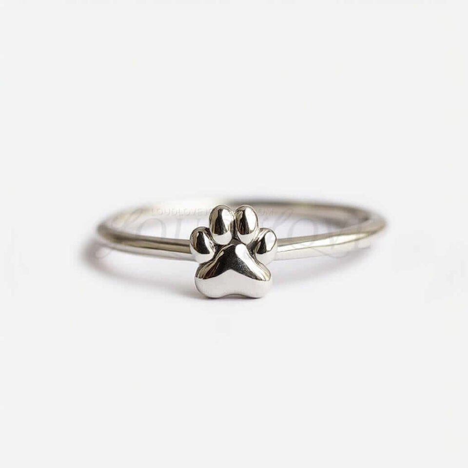 Silver ring with a raised paw print design shown from the front against a plain background.