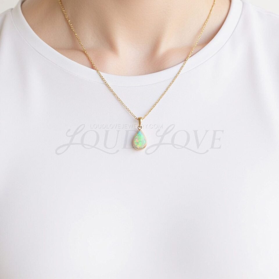 Ethereal opal in a pear shape worn for October, catching light with every movement.