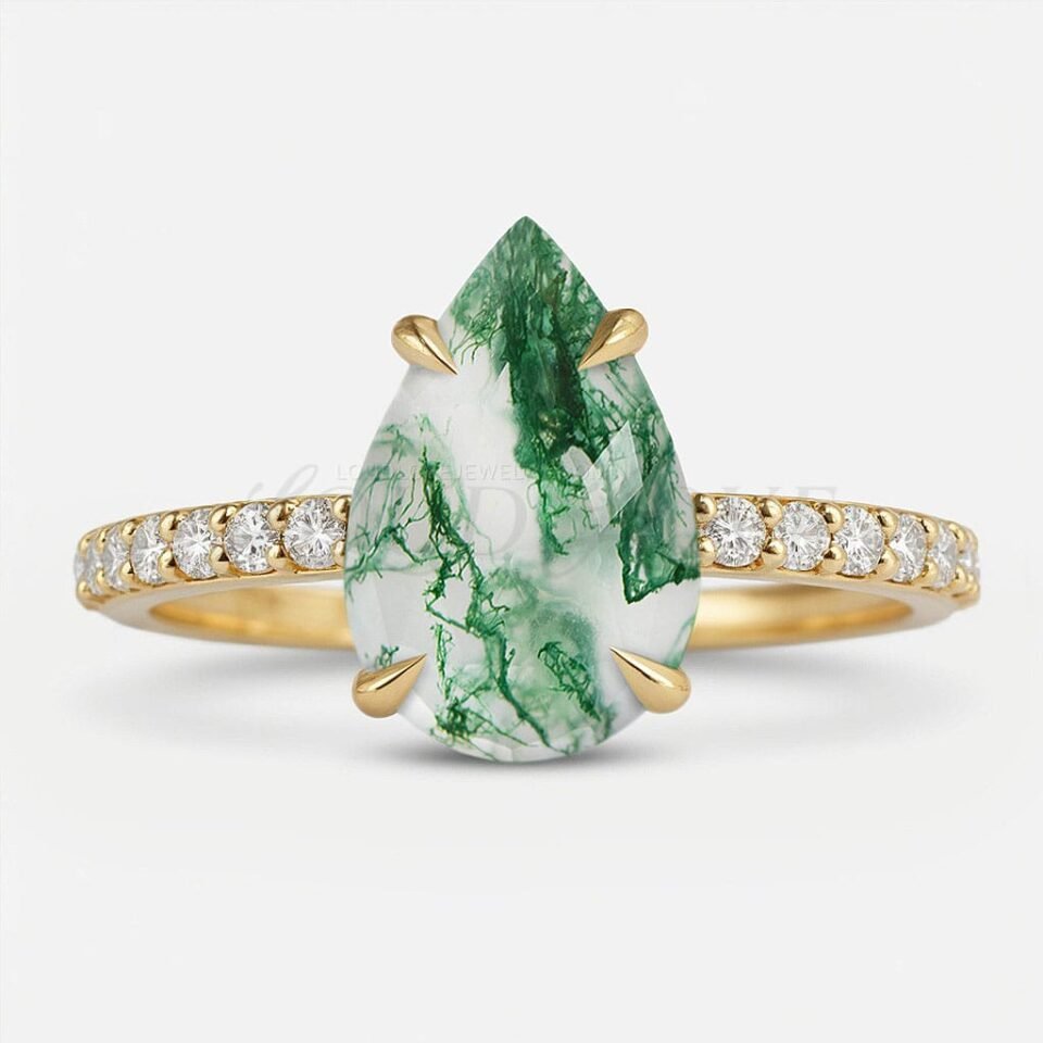 Pear-shaped moss agate in 4-prong setting with moissanites on the eternity band.