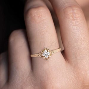 Vintage-inspired gold ring with princess moissanite and 4-claw prong setting.