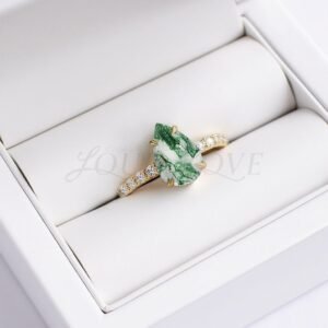 Moss agate pear-cut ring with moissanite eternity band styled as a unique engagement ring.