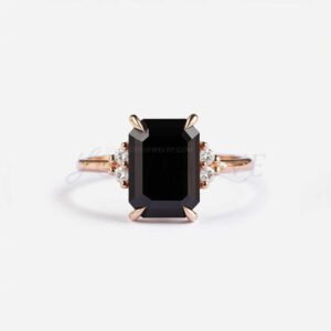 Emerald-cut black onyx framed by four white stones in a rose gold setting with bold contrast.