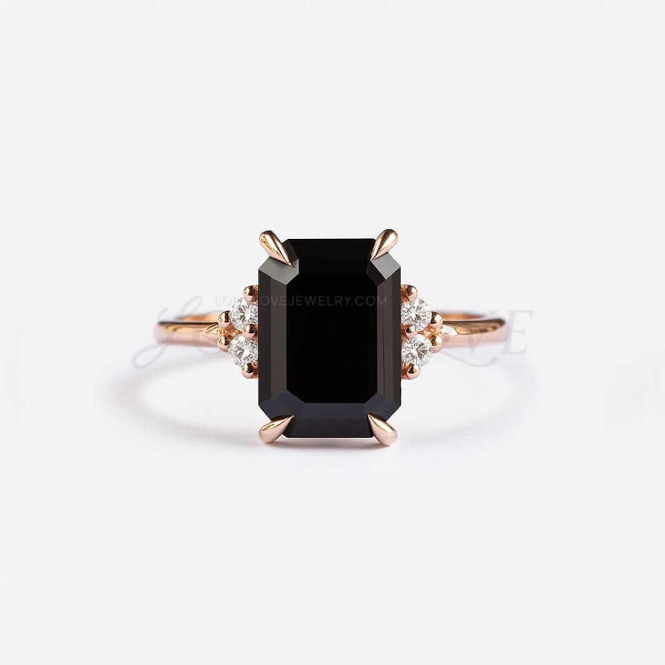 Emerald-cut black onyx framed by four white stones in a rose gold setting with bold contrast.